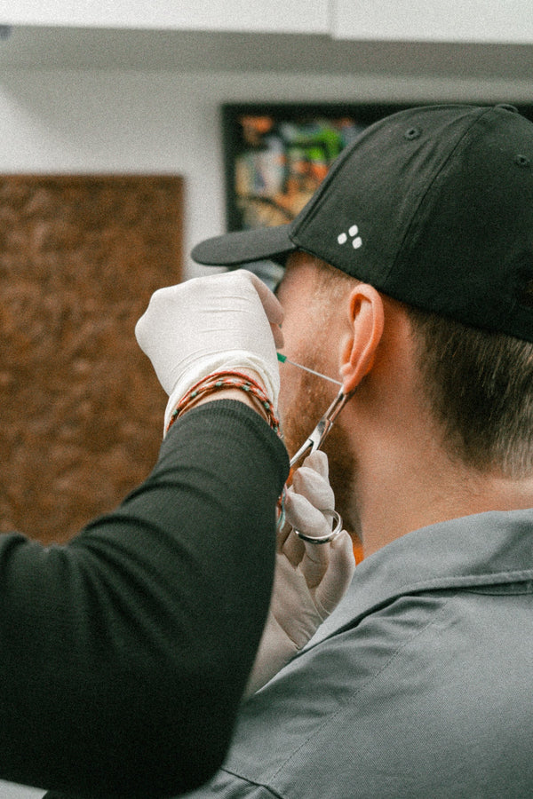 Professional piercer at work in the studio