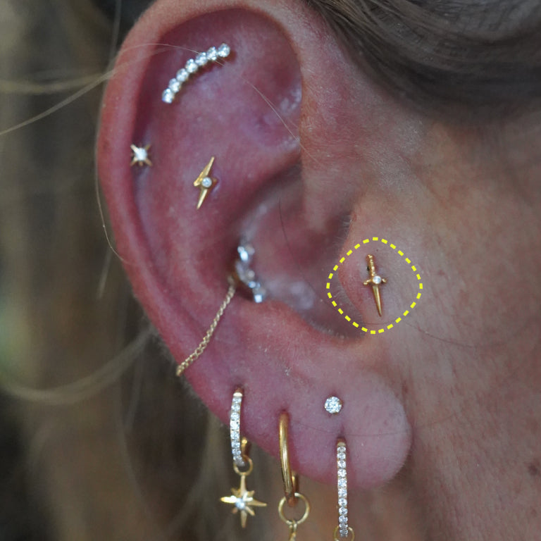 Dagger flatback earring worn on the ear