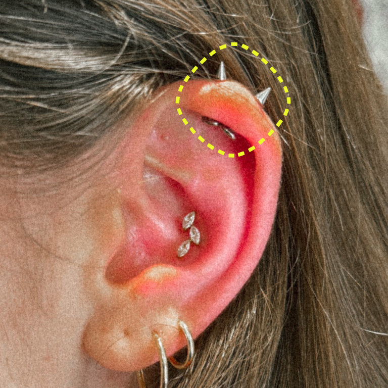 Spike flatback earring worn on the ear