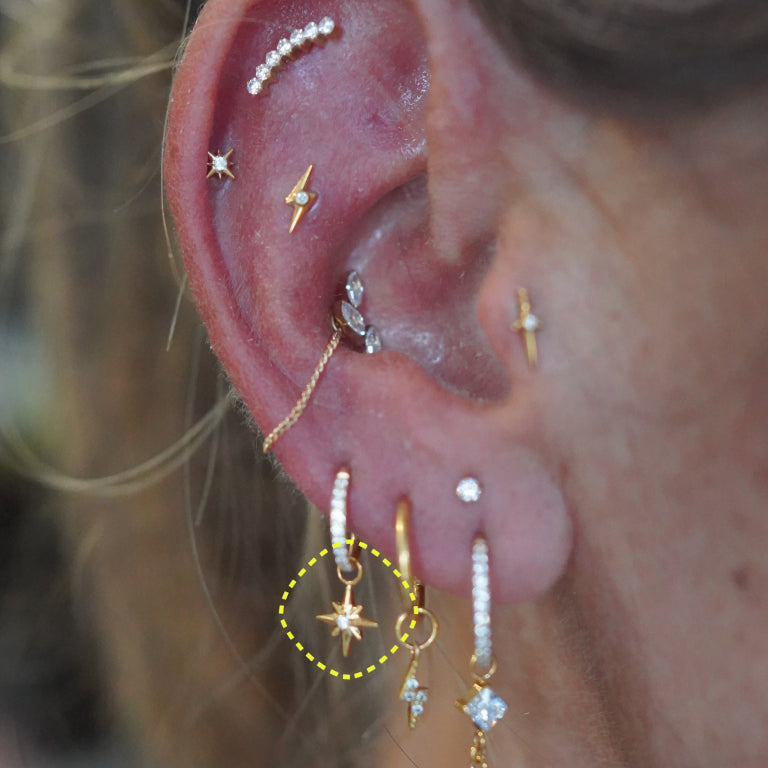 Star charm worn on a clicker hoop